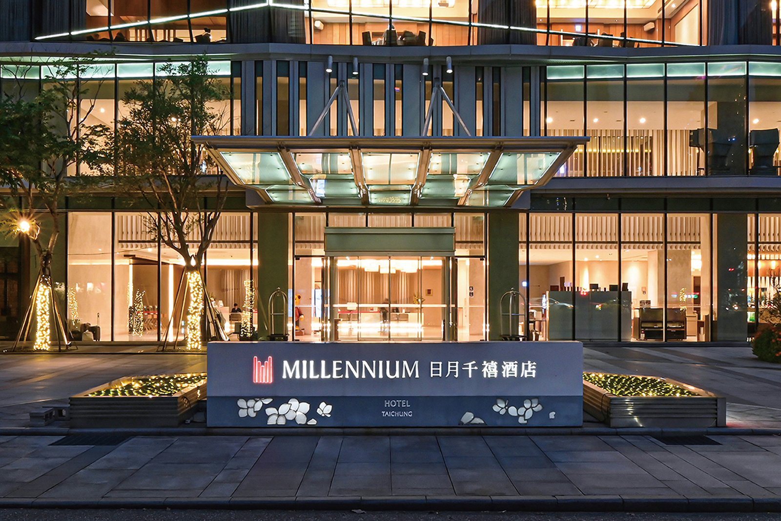 Front entrance of the Millennium Hotel Taichung at night, with the hotel sign in English and Chinese